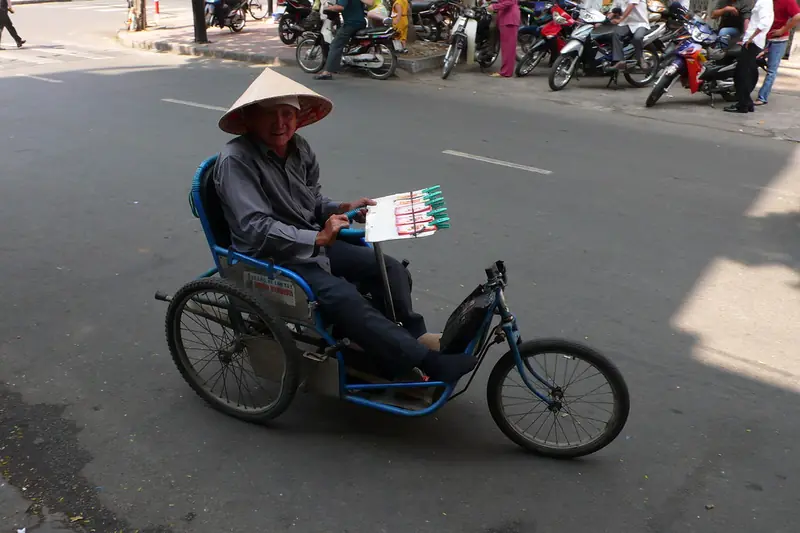 Người bán vé số trên xe lăn, một hình ảnh quen thuộc ở các thành phố phía Nam